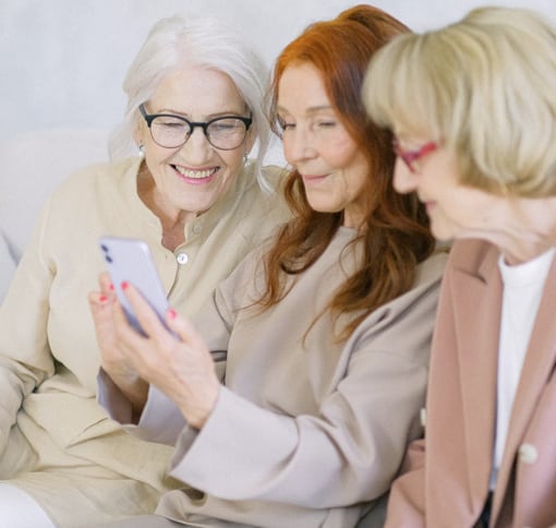 three women are using mobile phone to make video call