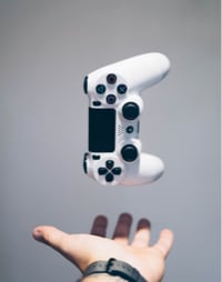 PS4 controller placed above a person's hand 